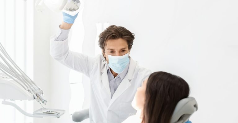 Attentive dentist listening to female patient in cabinet